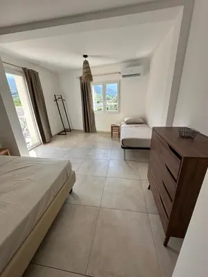 a bedroom with a bed and a dresser and a couch at Bergerie avec spa vue montagne in San-Nicolao