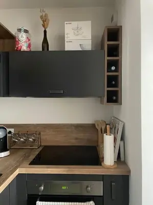 a kitchen with a counter with a stove top oven at Appartement T2 avec jardin in Lucciana