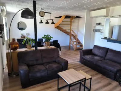 a living room with a couch and a table at Maison chaleureuse à Ajaccio avec vue sur le jardin in Ajaccio