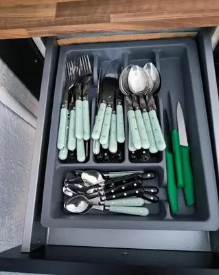 a tray filled with utensils in a drawer at Maison chaleureuse à Ajaccio avec vue sur le jardin in Ajaccio
