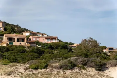 a group of houses on a hill on a beach at Villa Tizzano Vue Mer in Sartène