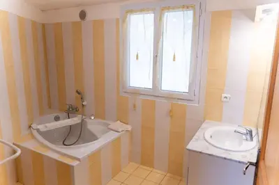 a bathroom with a tub and a sink at Villa Tizzano Vue Mer in Sartène