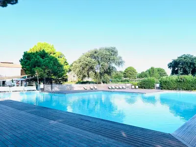 a large swimming pool with blue water at T2 Neuf à 800 m de la plage de Cala Rossa appart n 80 in Lecci