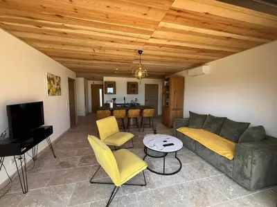 a living room with a couch and chairs and a table at 