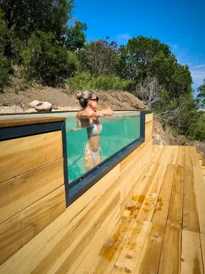 a woman in a swimming pool on a wooden deck at 