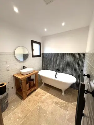a bathroom with a tub and a sink and a mirror at 