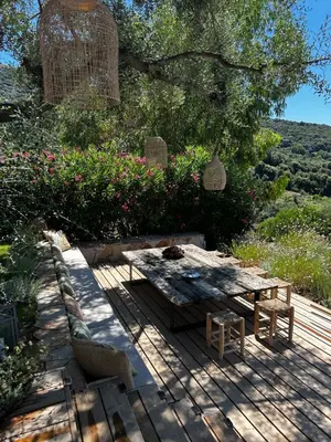 a picnic table and bench on a wooden deck at La Bergerie de l'Alivettu en Corse in Alata