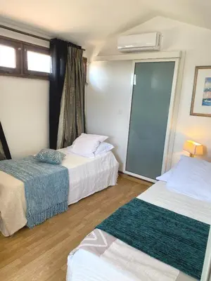 a hotel room with two beds and a mirror at SCI MD in Porto-Vecchio