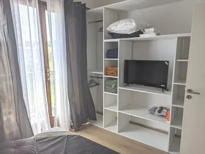 a living room with a tv and a window at SCI MD in Porto-Vecchio