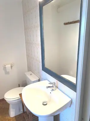a bathroom with a sink and a toilet and a mirror at SCI MD in Porto-Vecchio