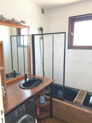 a bathroom with a sink and a mirror at SCI MD in Porto-Vecchio