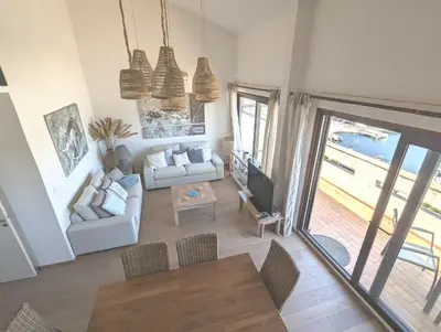 a living room with a couch and a tv at SCI MD in Porto-Vecchio