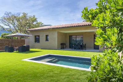 a backyard with a swimming pool and a house at Casa Omigna in Figari