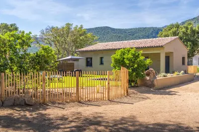 a fence in front of a house at Casa Omigna in Figari