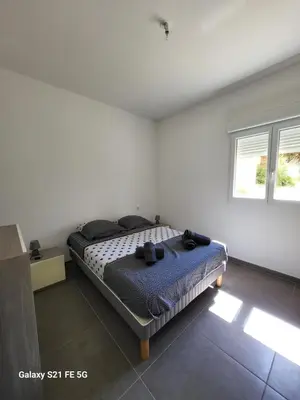 a bedroom with a bed in a white room at T2 bord de mer in Albitreccia