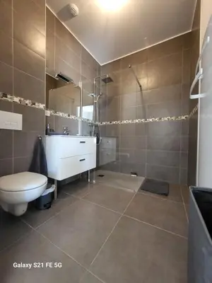 a bathroom with a toilet and a sink and a shower at T2 bord de mer in Albitreccia