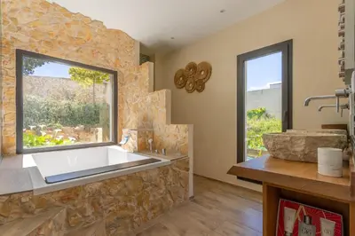 a bathroom with a large sink and a window at Maison O Ciucciarella - Climatisée avec jacuzzi in Grosseto-Prugna