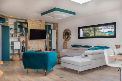 a living room with a couch and a tv at Maison O Ciucciarella - Climatisée avec jacuzzi in Grosseto-Prugna