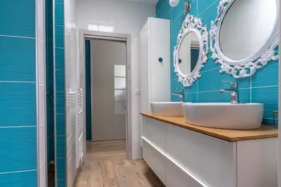 a bathroom with two sinks and a mirror at Maison O Ciucciarella - Climatisée avec jacuzzi in Grosseto-Prugna