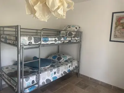 a bunk room with two bunk beds in it at Villa bord de mer avec piscine 200 métres plage in Zonza