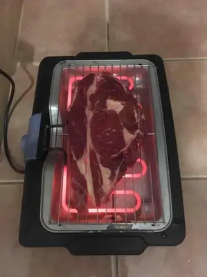 a piece of meat cooking in an oven at Villa VESTA 62m2 à St Cyprien 700 m de la plage et du village in Lecci