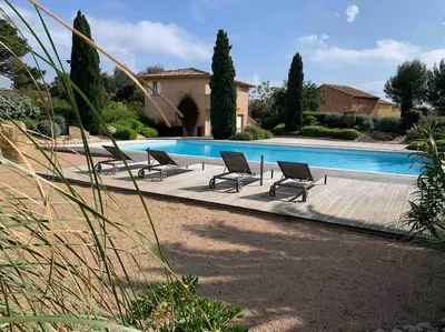 a group of chairs sitting next to a swimming pool at Villa VESTA 62m2 à St Cyprien 700 m de la plage et du village in Lecci