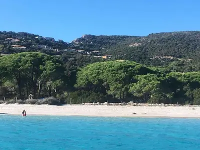 a person standing in the water on a beach at Villa VESTA 62m2 à St Cyprien 700 m de la plage et du village in Lecci