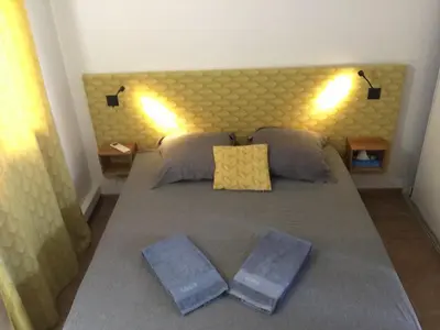 a bedroom with a large bed with two pillows at Villa VESTA 62m2 à St Cyprien 700 m de la plage et du village in Lecci