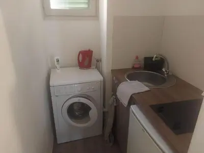 a small bathroom with a washing machine and a sink at AJACCIO Beau Studio pour 3 a 4 pers en Plein Centre de la Vieille Ville Historique in Ajaccio