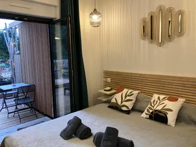 a bedroom with a bed with two pillows on it at Villa luxury vue mer à 300m du centre ville terrasse,jardin,parking privé in Porto-Vecchio