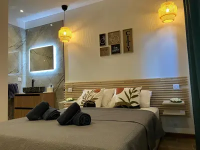 a bedroom with a bed with black pillows on it at Villa luxury vue mer à 300m du centre ville terrasse,jardin,parking privé in Porto-Vecchio