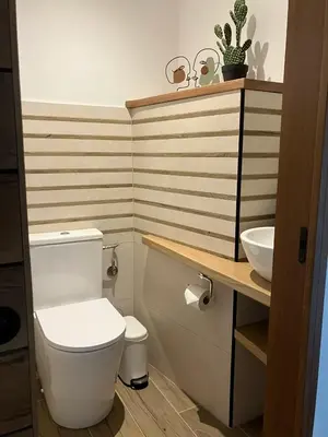 a bathroom with a white toilet and a sink at Villa luxury vue mer à 300m du centre ville terrasse,jardin,parking privé in Porto-Vecchio