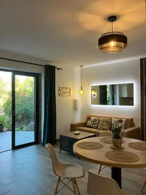 a living room with a couch and a table at Villa luxury vue mer à 300m du centre ville terrasse,jardin,parking privé in Porto-Vecchio