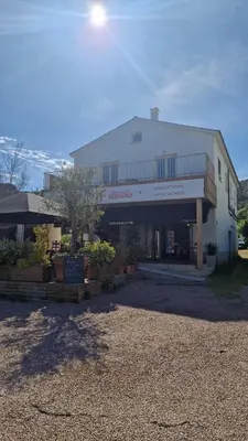 a building with a sign in front of it at Magnifique! Idéal! in Grosseto-Prugna