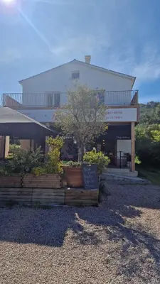 a building with a tree in front of it at Magnifique! Idéal! in Grosseto-Prugna