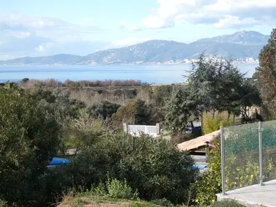 a view of a body of water with mountains at Corsicadream Barbicaja, superbe appartement dans villa, vue panoramique mer, piscine, proche Porticcio in Pietrosella