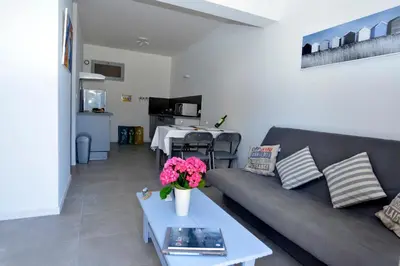 a living room with a couch and a table at Corsicadream Barbicaja, superbe appartement dans villa, vue panoramique mer, piscine, proche Porticcio in Pietrosella