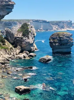 a view of a body of water with rocks at Duplex avec piscine, près de la mer, Cala Rossa in Lecci