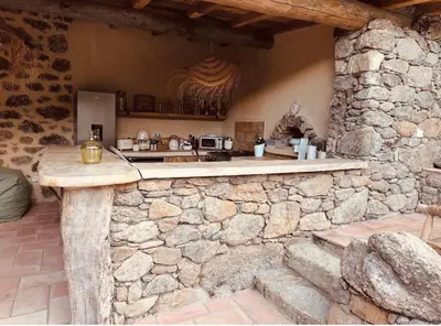 a stone kitchen with a counter in a stone wall at La Casa D'Ange Bergerie 5 étoiles de Luxe Piscine chauffée in Lama