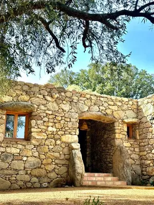 a stone building with a door and a window at La Casa D'Ange Bergerie 5 étoiles de Luxe Piscine chauffée in Lama