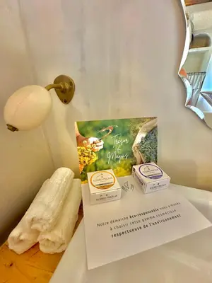 a sign on a table with a book and a lamp at La Casa D'Ange Bergerie 5 étoiles de Luxe Piscine chauffée in Lama