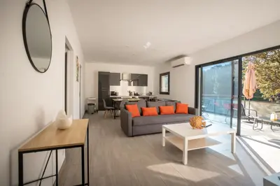 a living room with a couch and a table at Casa Emma in Sollacaro