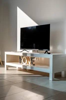 a white entertainment center with a tv on top of it at Casa Emma in Sollacaro