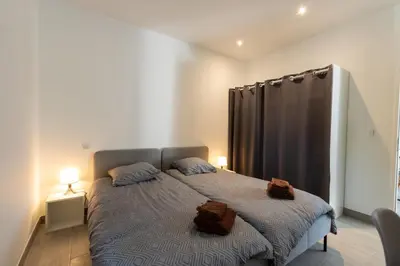 a bedroom with a bed with two towels on it at Casa Emma in Sollacaro