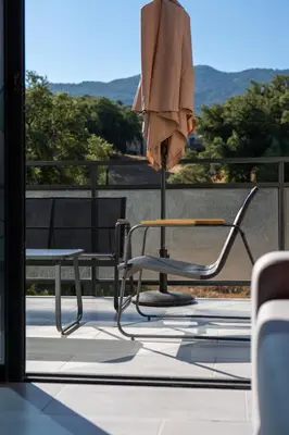 a chair and an umbrella sitting on a patio at Casa Emma in Sollacaro