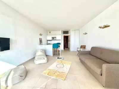 a living room with a couch and a table at Studio Cosy à 50m de la plage avec Parking - Résidence ARIA MARINA route des sanguinaires in Ajaccio