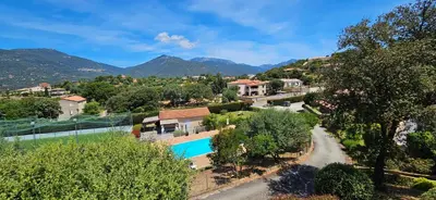 an aerial view of a resort with a swimming pool and mountains at T2 Résidence Dolce & Vita C5 vue mer et piscine in Propriano