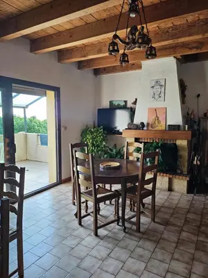 a dining room with a wooden table and chairs at Ferme Auberge U Cantu d'Adelio in Olivese