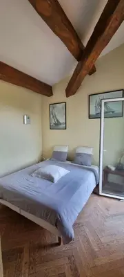 a bedroom with a large bed and a mirror at Maison accès direct plage corse du sud in Coti-Chiavari