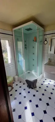 a bathroom with a shower and a tiled floor at Maison accès direct plage corse du sud in Coti-Chiavari